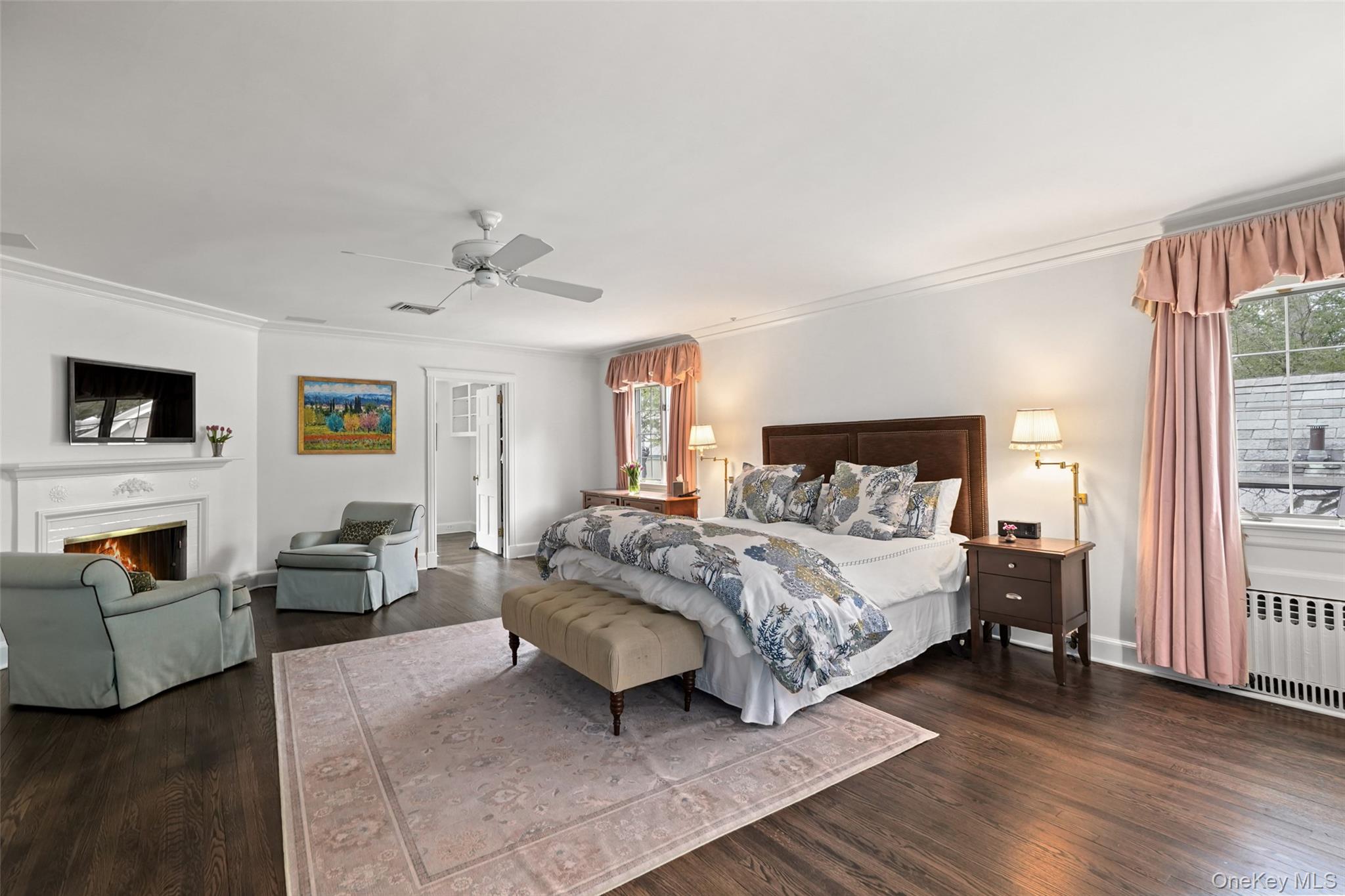 49 Moore Road Bronxville, NY 10708 - Photo 16 of 46 a spacious bedroom with a bed a couch and a window