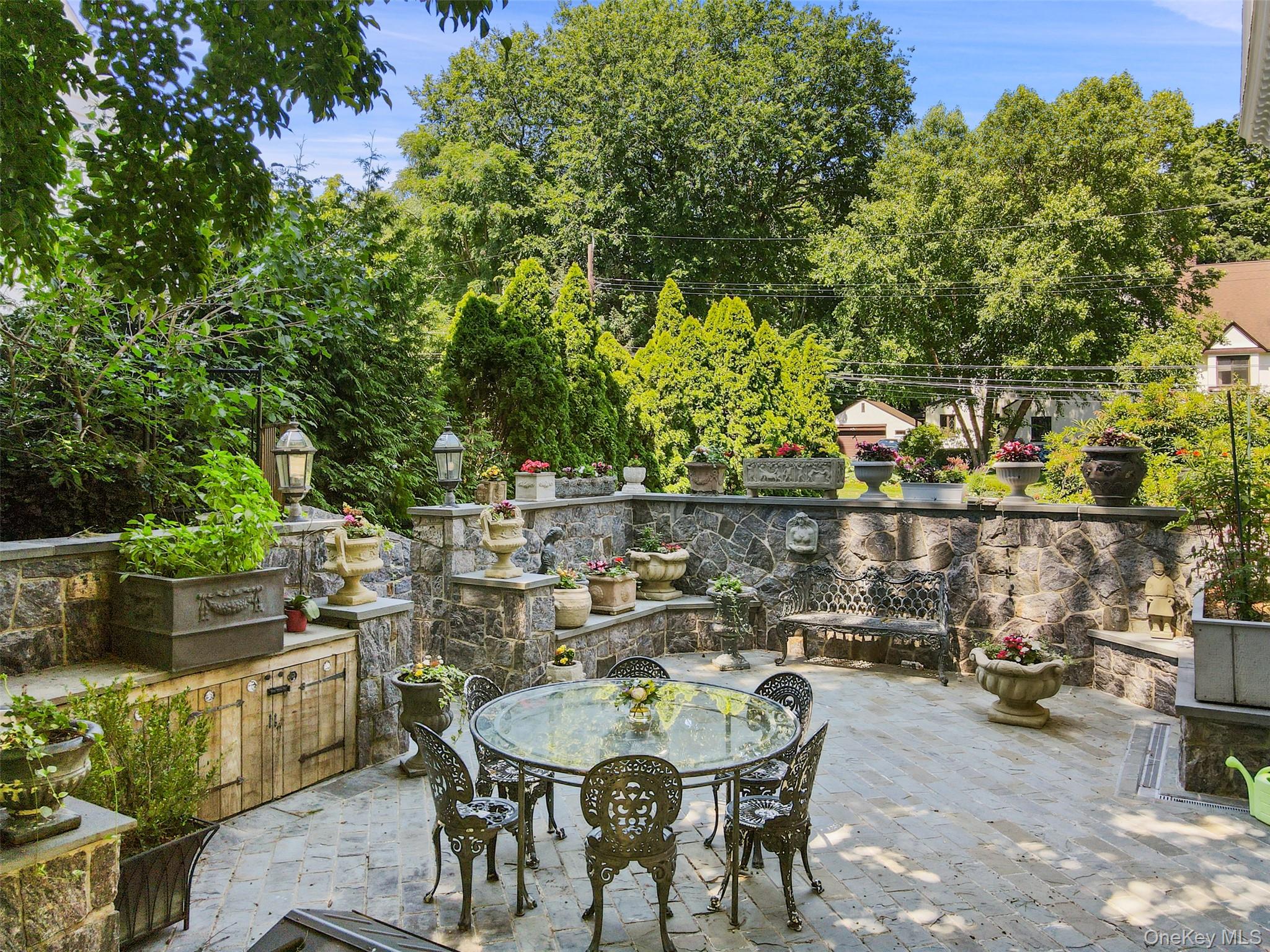 49 Moore Road Bronxville, NY 10708 - Photo 35 of 46 a roof deck with table and chairs and potted plants