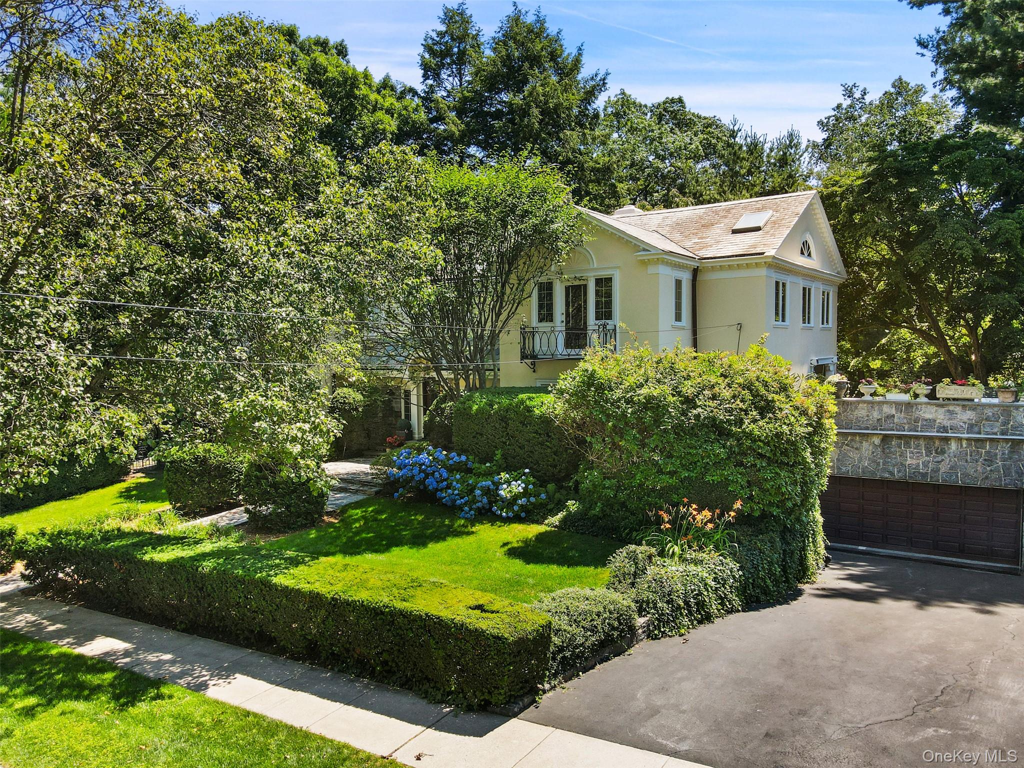 49 Moore Road Bronxville, NY 10708 - Photo 39 of 46 a view of a white house with a yard and potted plants
