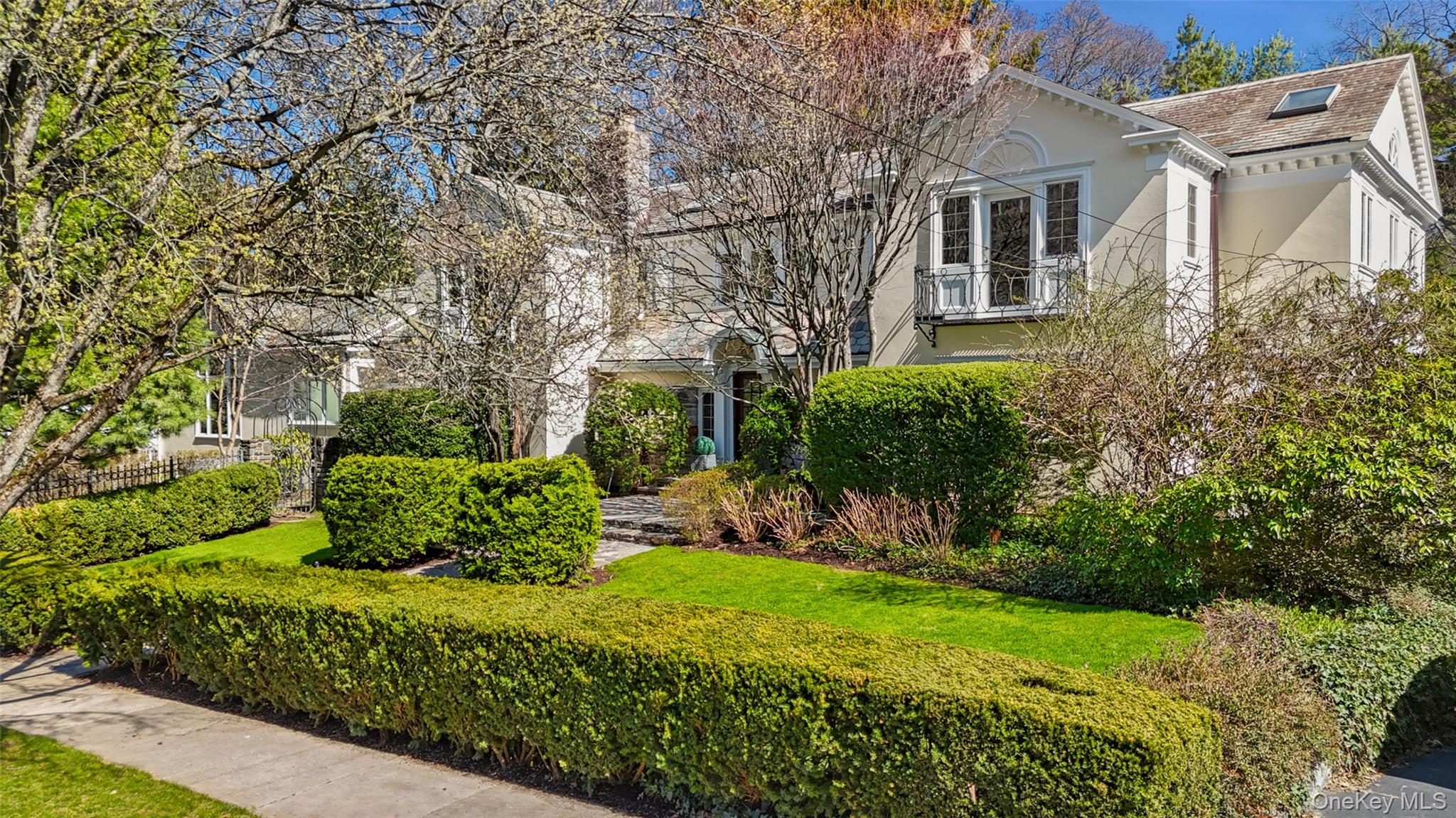 49 Moore Road Bronxville, NY 10708 - Photo 41 of 46 a view of a house with a yard and flower plants