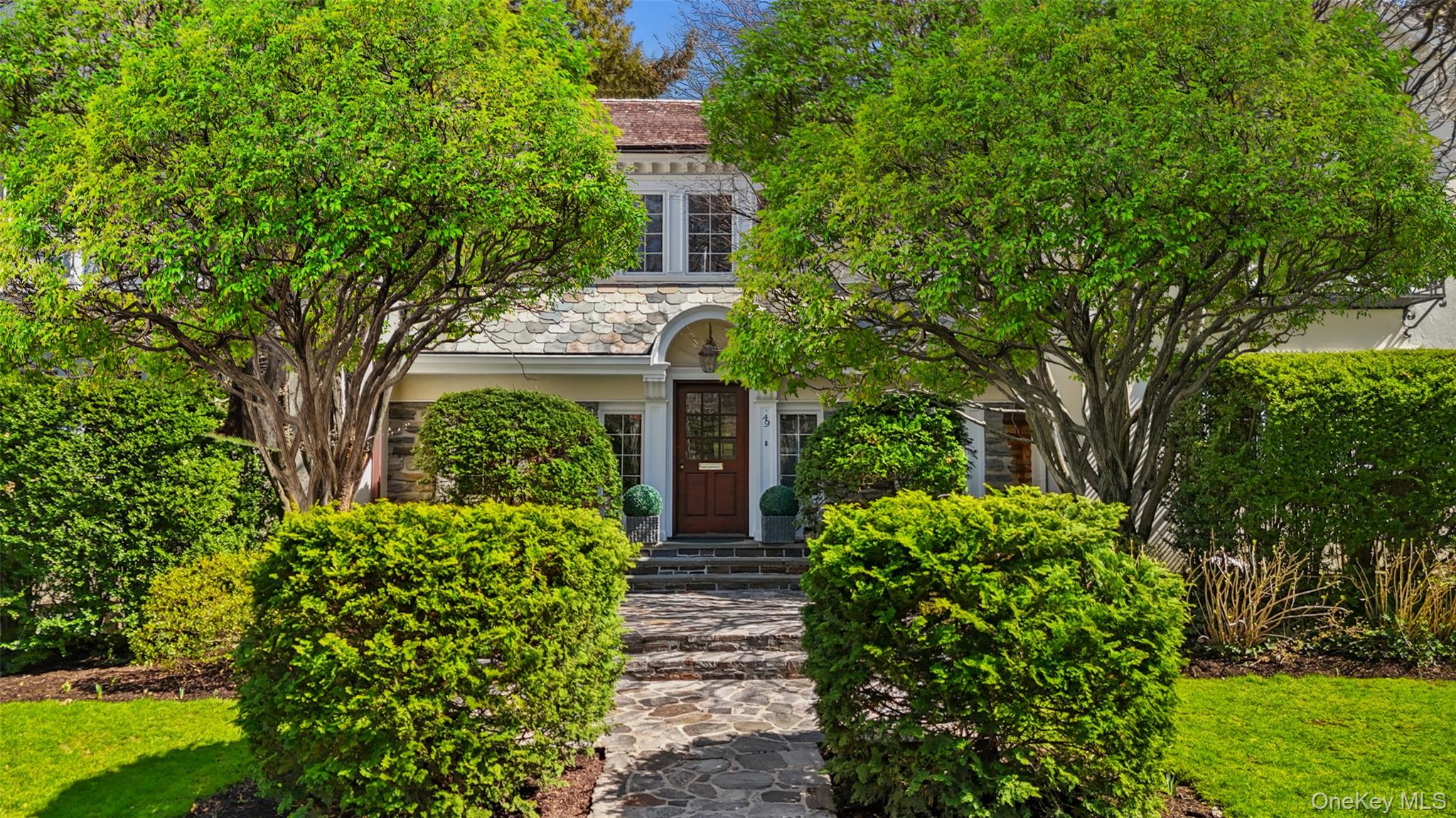 49 Moore Road Bronxville, NY 10708 - Photo 42 of 46 a view of house with garden and flowers