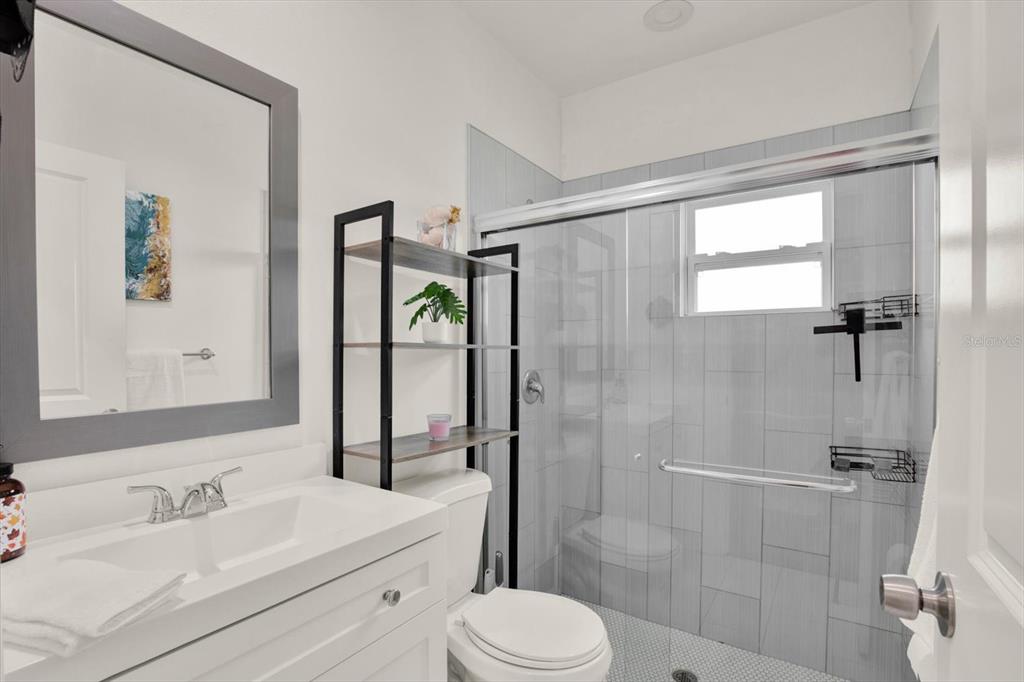 3023 Muir Street Holiday, FL 34691 - Photo 14 of 25 a bathroom with a sink toilet and shower