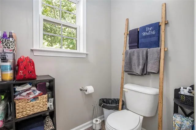 a kitchen with stainless steel appliances granite countertop a stove top oven a sink dishwasher a dining table and chairs with wooden floor