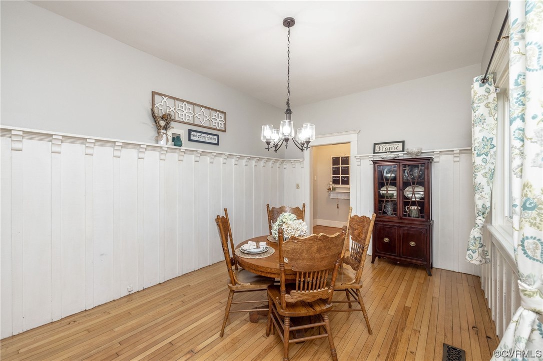 2731 Sherbourne Road Richmond, VA 23237 - Photo 14 of 45 a view of a dining room with furniture wooden floor and chandelier
