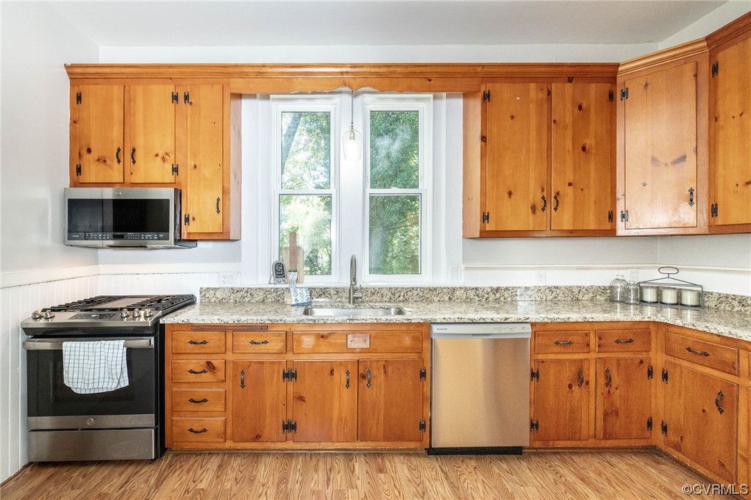 2731 Sherbourne Road Richmond, VA 23237 - Photo 19 of 45 a kitchen with stainless steel appliances granite countertop a stove and a microwave