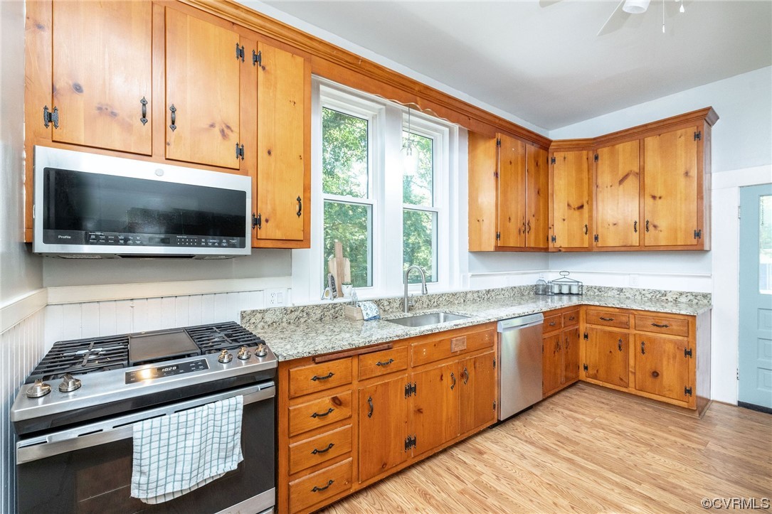 2731 Sherbourne Road Richmond, VA 23237 - Photo 20 of 45 a kitchen with stainless steel appliances granite countertop a stove a sink and a microwave