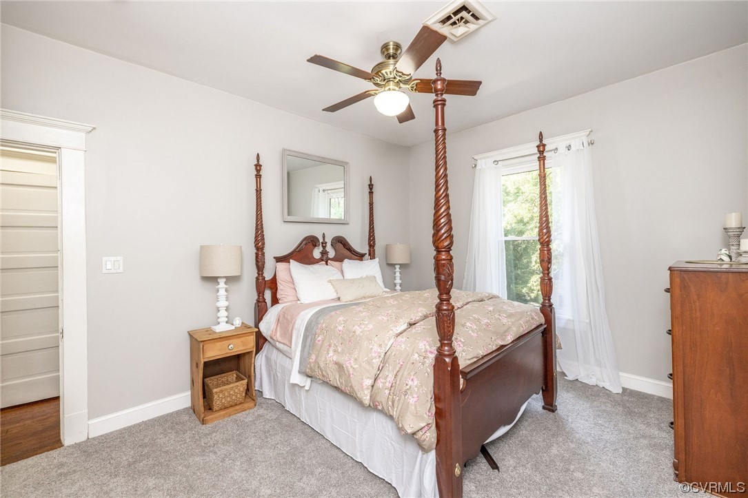 2731 Sherbourne Road Richmond, VA 23237 - Photo 28 of 45 a bedroom with a bed and a chandelier