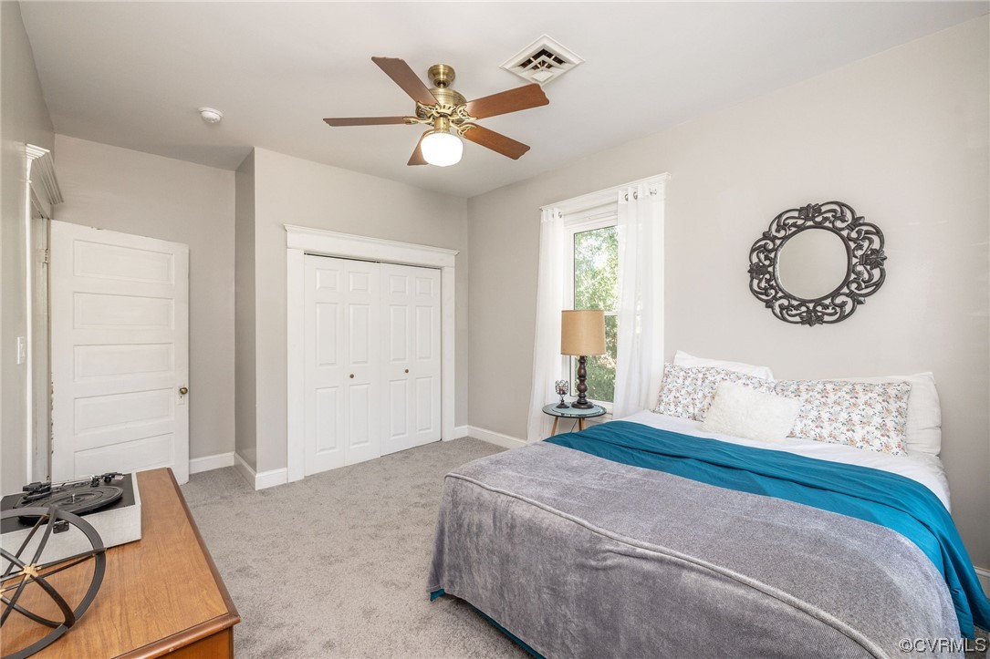 2731 Sherbourne Road Richmond, VA 23237 - Photo 35 of 45 a bedroom with a large bed and a chandelier
