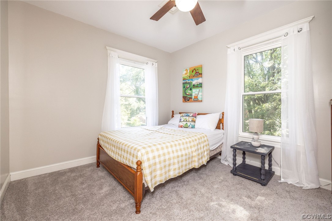 2731 Sherbourne Road Richmond, VA 23237 - Photo 36 of 45 a bedroom with a bed a window and a chandelier