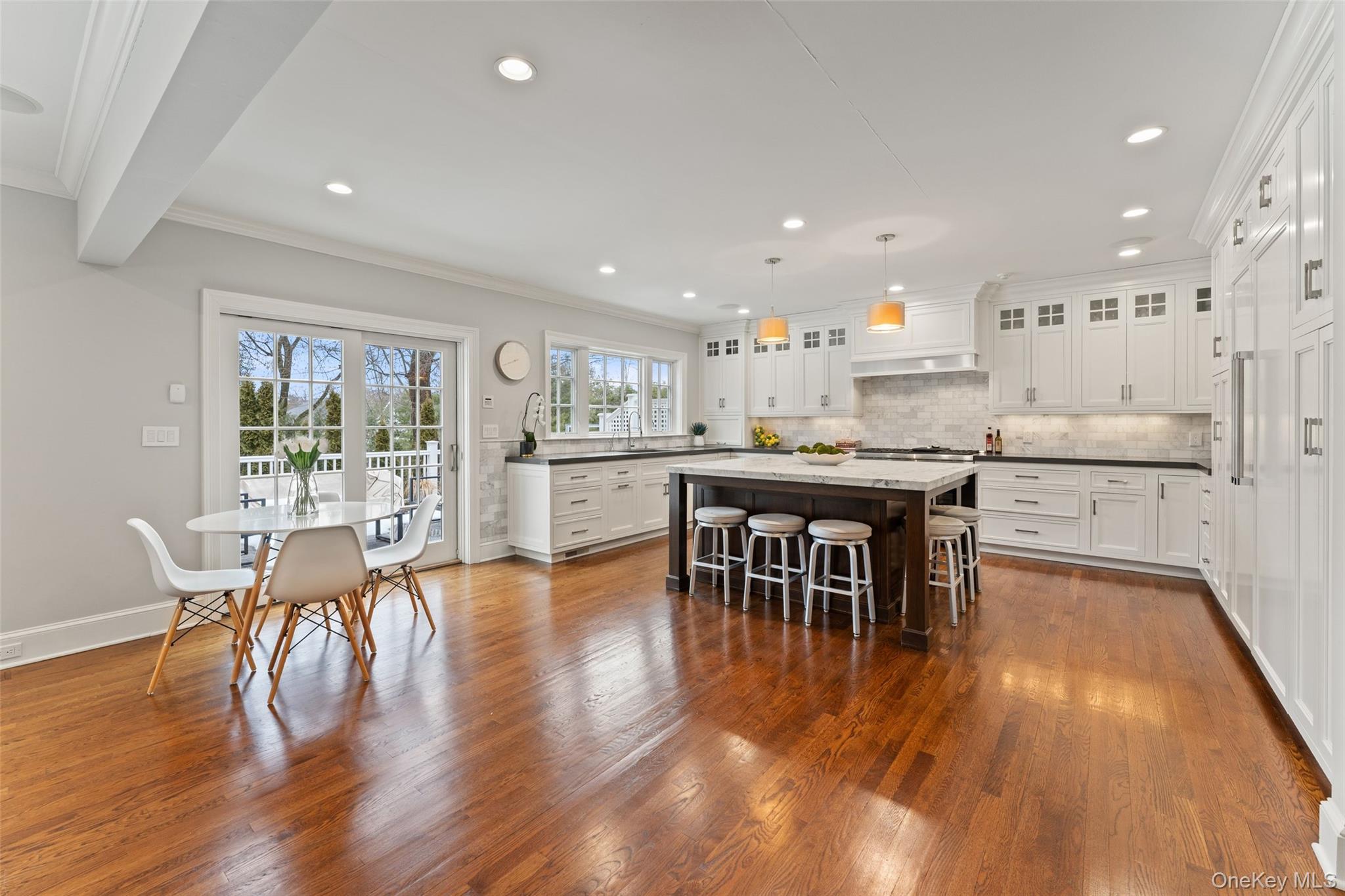 326 Heathcote Road Scarsdale, NY 10583 - Photo 10 of 40 Renovated, eat-in kitchen with breakfast area and French doors for seamless indoor/outdoor entertaining.