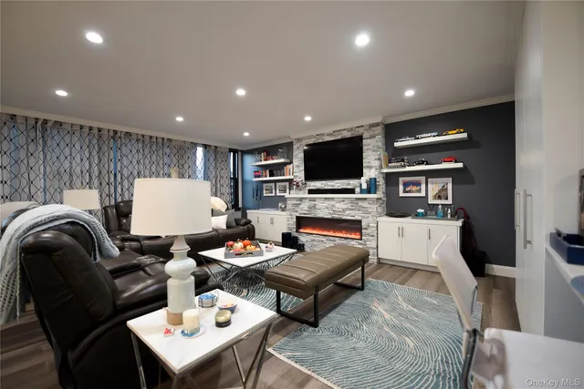 a living room with furniture a fireplace and a flat screen tv