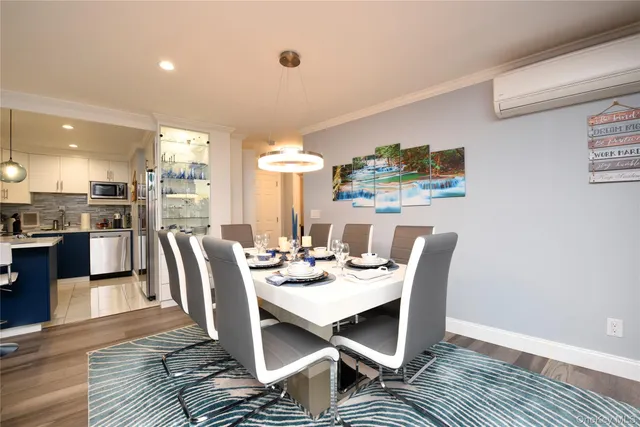 a view of a dining room with furniture window and wooden floor