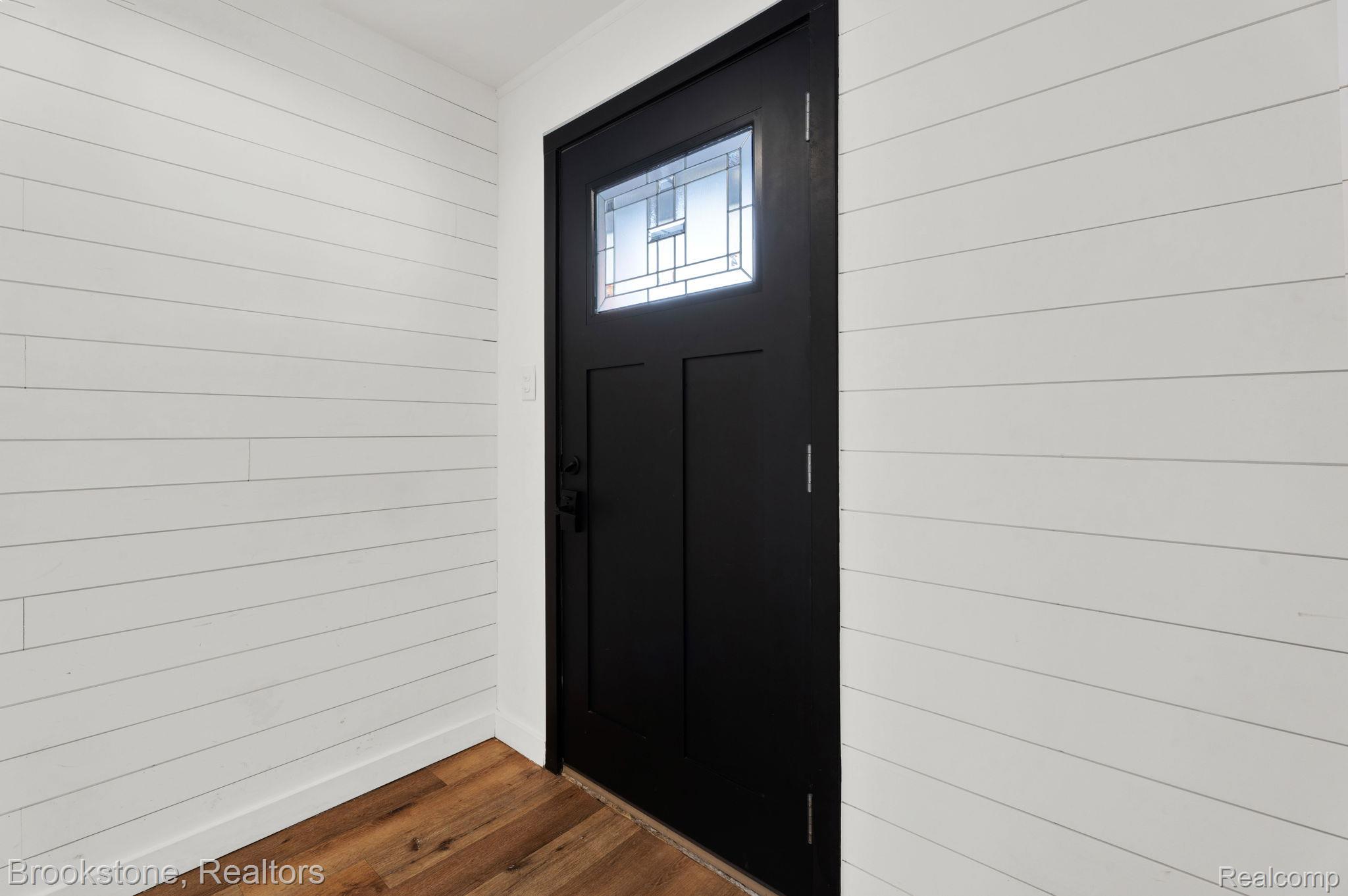16046 West 13 Mile Road Franklin, MI 48025 - Photo 3 of 31 Foyer with dark wood-type flooring and wood walls