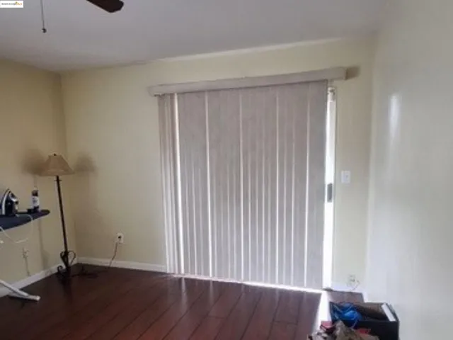 a view of an empty room and wooden floor