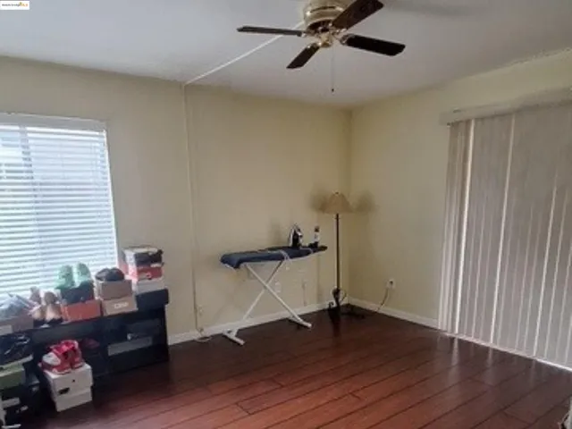 a view of a room with wooden floor and window