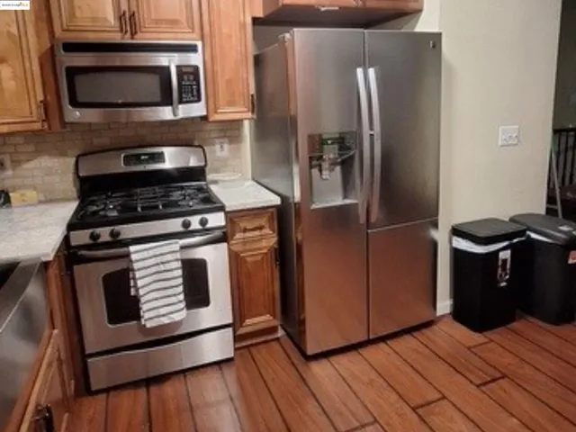 a kitchen with wooden cabinets and a stove top oven