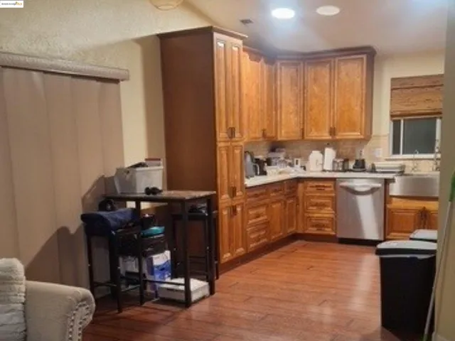 a kitchen with a wooden cabinets and chairs
