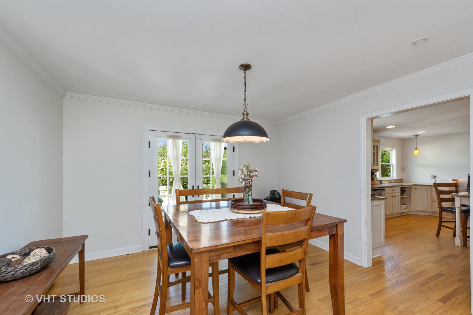 237 Valley Road Trout Valley, IL 60013 - Photo 8 of 48 a dining room with furniture wooden floor a rug and a chandelier
