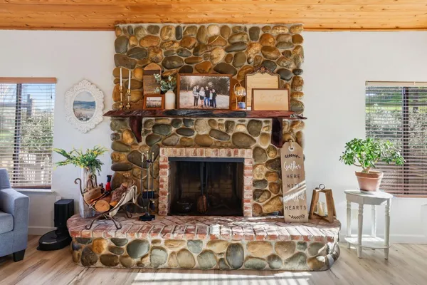 a living room with a fireplace with wooden floor