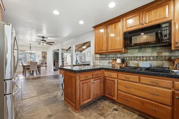 a kitchen with stainless steel appliances granite countertop a sink stove and microwave