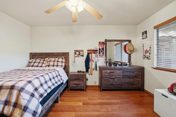 a bedroom with furniture and a wooden floor