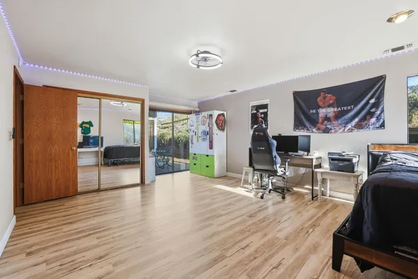 a bedroom with furniture and a wooden floor