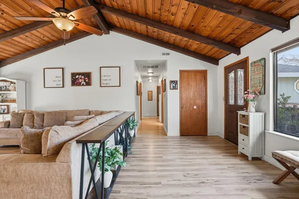 a living room with furniture and a wooden floor