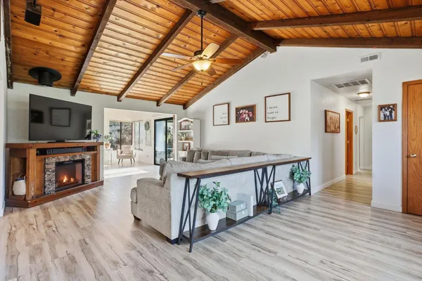 a living room with furniture a fireplace and wooden floor