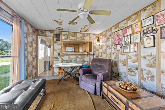 a living room with furniture a fireplace and a large window