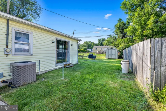 a view of a house with a big yard and potted plants