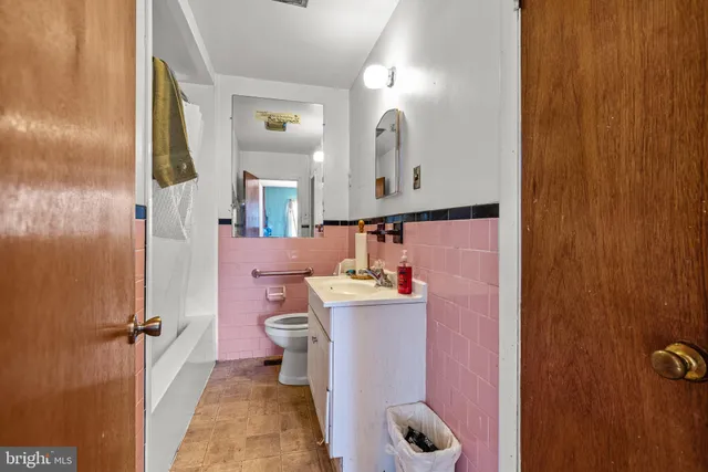 a bathroom with a sink a toilet and shower curtain