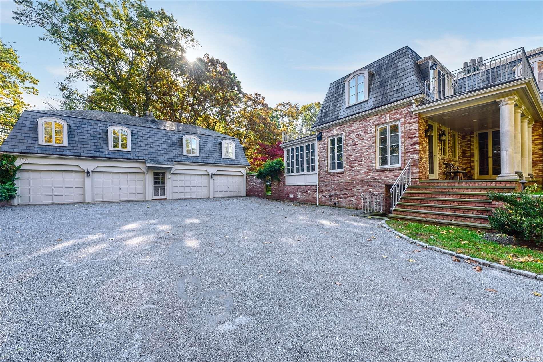 214 Cleft Road Mill Neck, NY 11765 - Photo 31 of 36 a front view of a house with a yard and garage