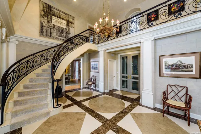 a view of a livingroom with furniture stairs and a chandelier