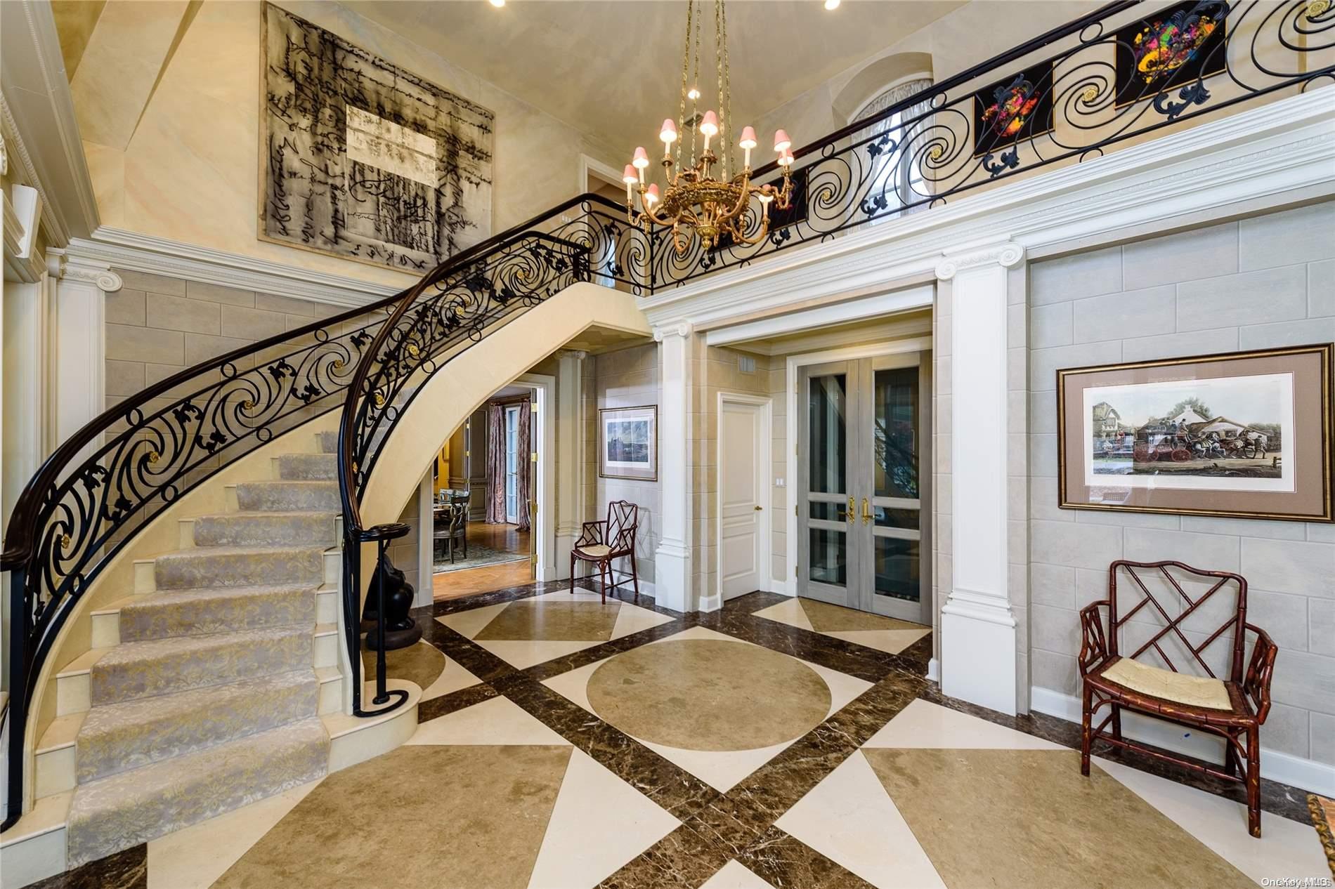 214 Cleft Road Mill Neck, NY 11765 - Photo 4 of 36 a view of a livingroom with furniture stairs and a chandelier