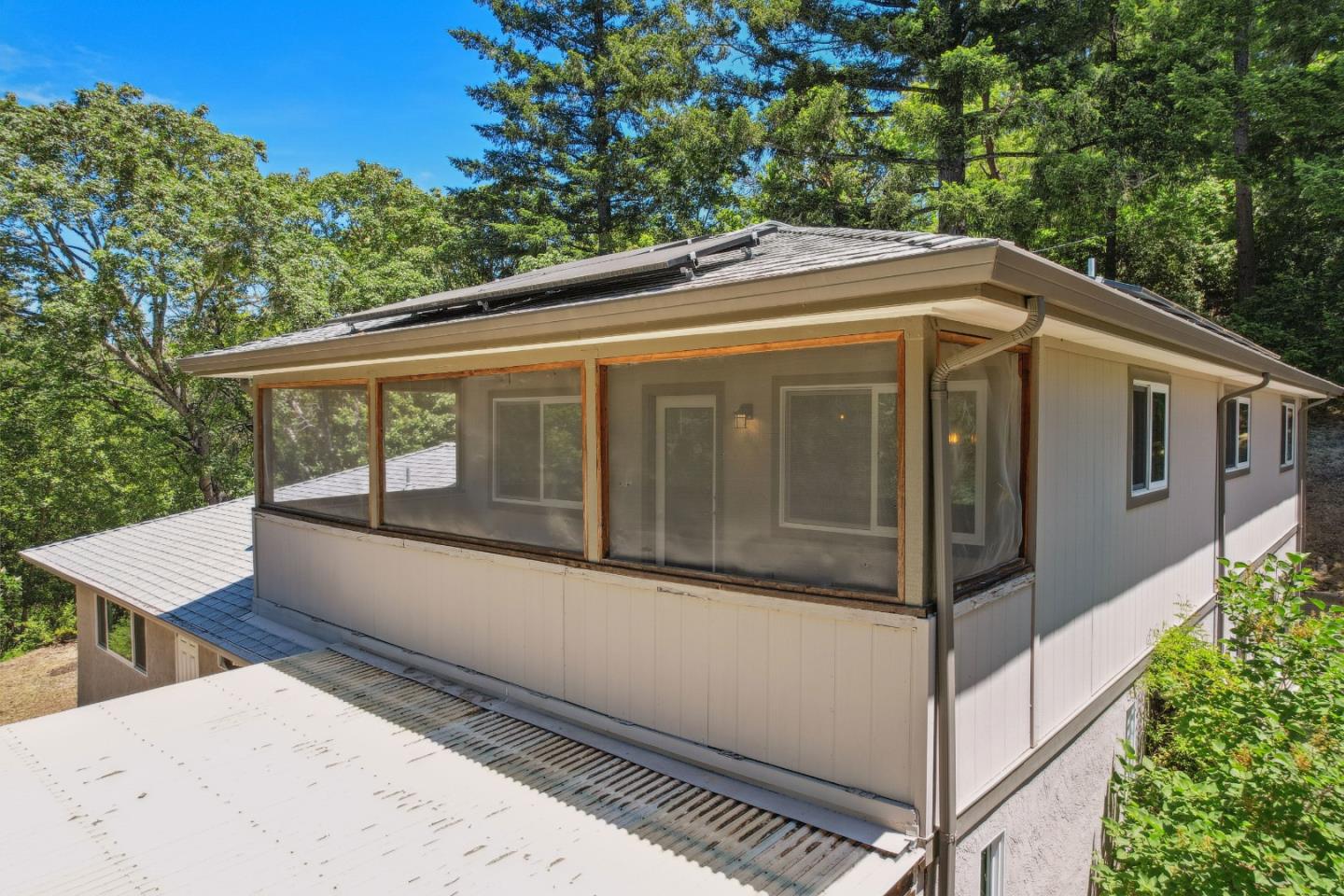 24895 Skyland Road Los Gatos, CA 95033 - Photo 73 of 113 a view of a white house with a large window and large tree