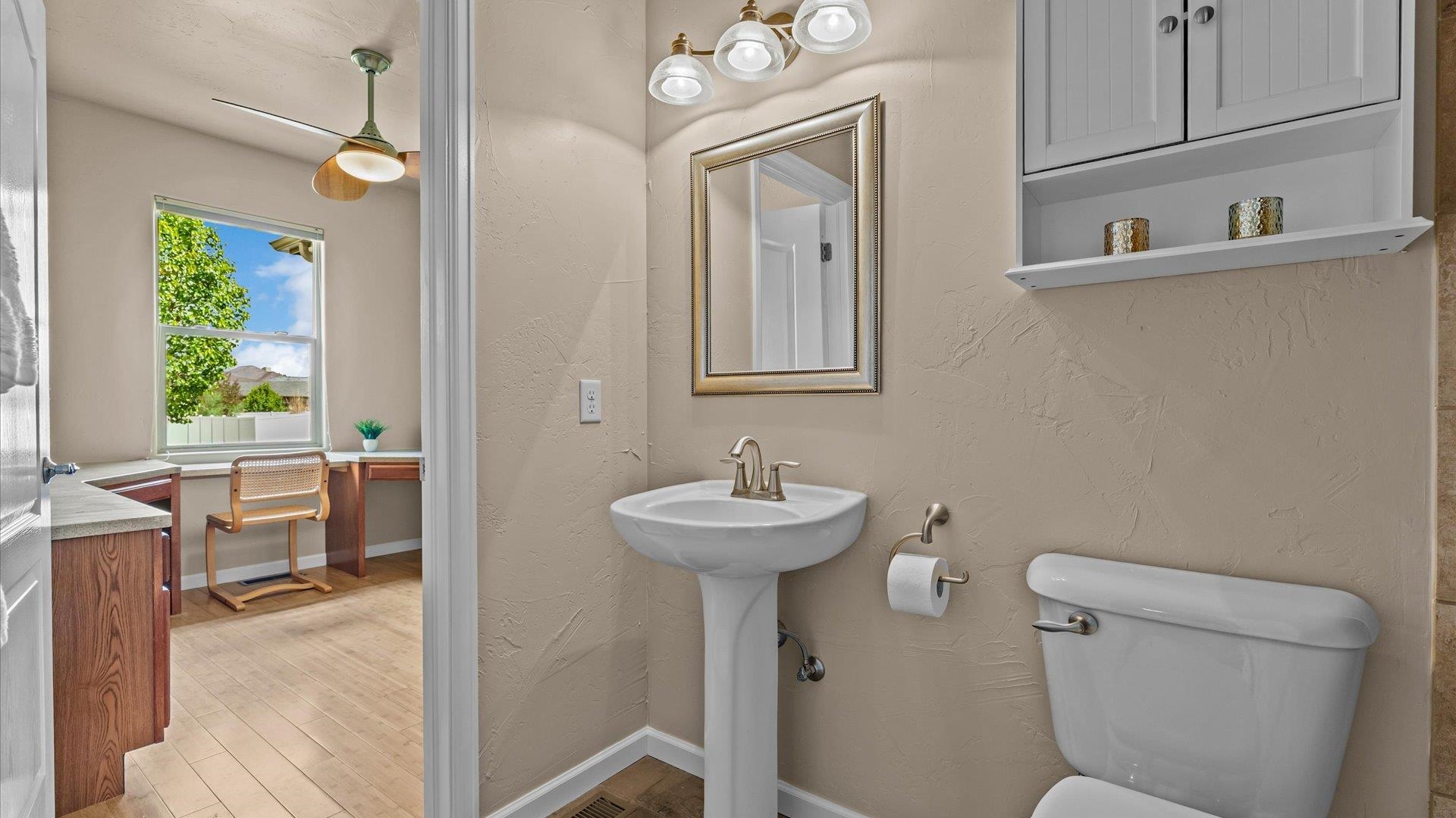 1712 Powis Lane Fruita, CO 81521 - Photo 30 of 39 a bathroom with a sink a toilet and mirror