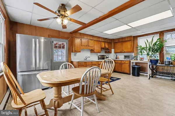 a open kitchen with a dining table and chairs with wooden floor