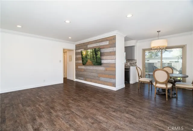 a view of a work space with wooden floor and furniture