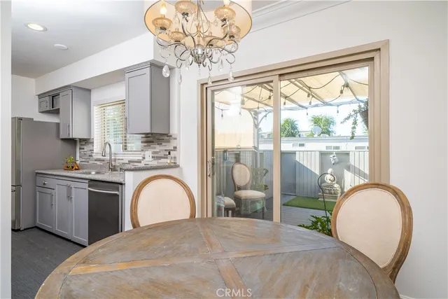 a spacious bedroom with a large bed and a chandelier