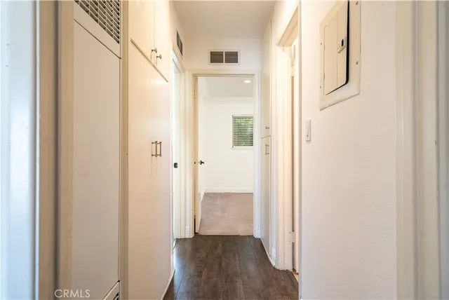 a view of a hallway with wooden floor