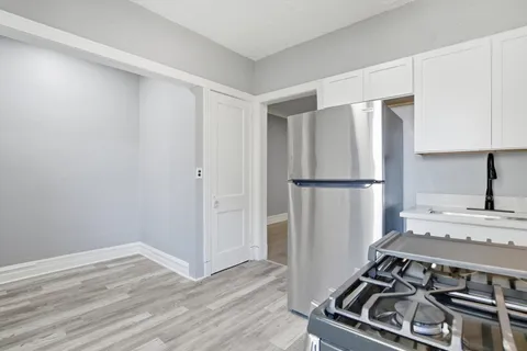 a kitchen with a stove and a refrigerator