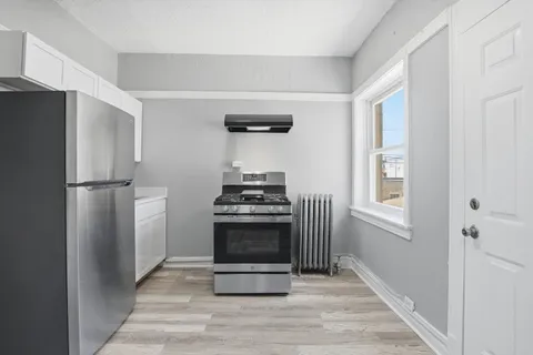 a kitchen with stainless steel appliances a refrigerator and a stove