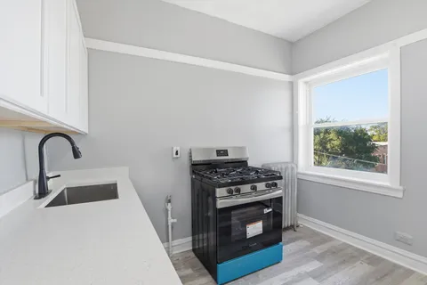 a kitchen with a stove and a sink