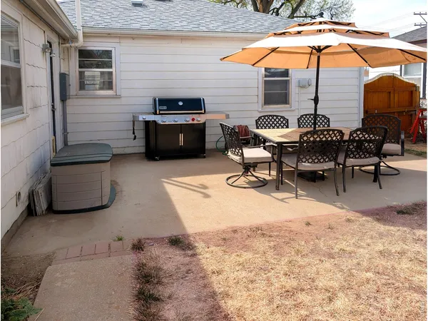 a patio with table and chairs