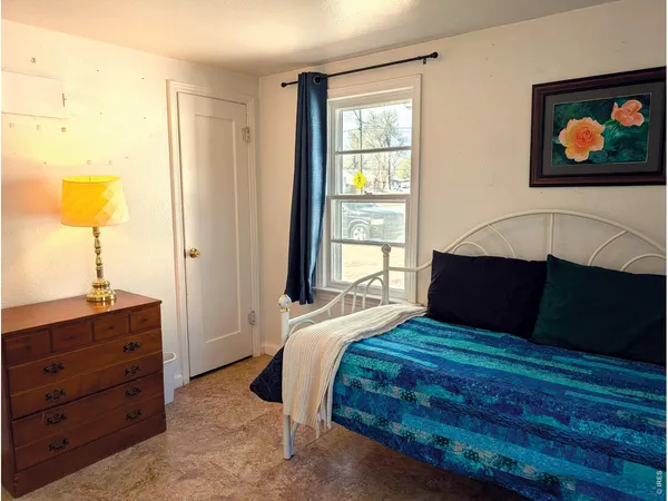 a bedroom with a bed and a window