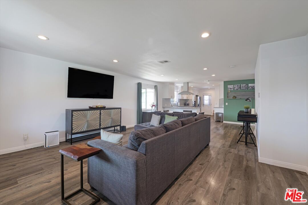 3447 9th Avenue Los Angeles, CA 90018 - Photo 4 of 18 a living room with furniture and a flat screen tv