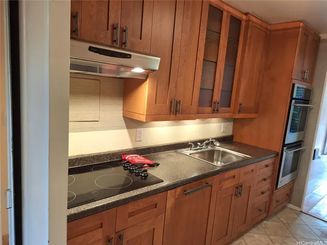 a kitchen with sink refrigerator and cabinets