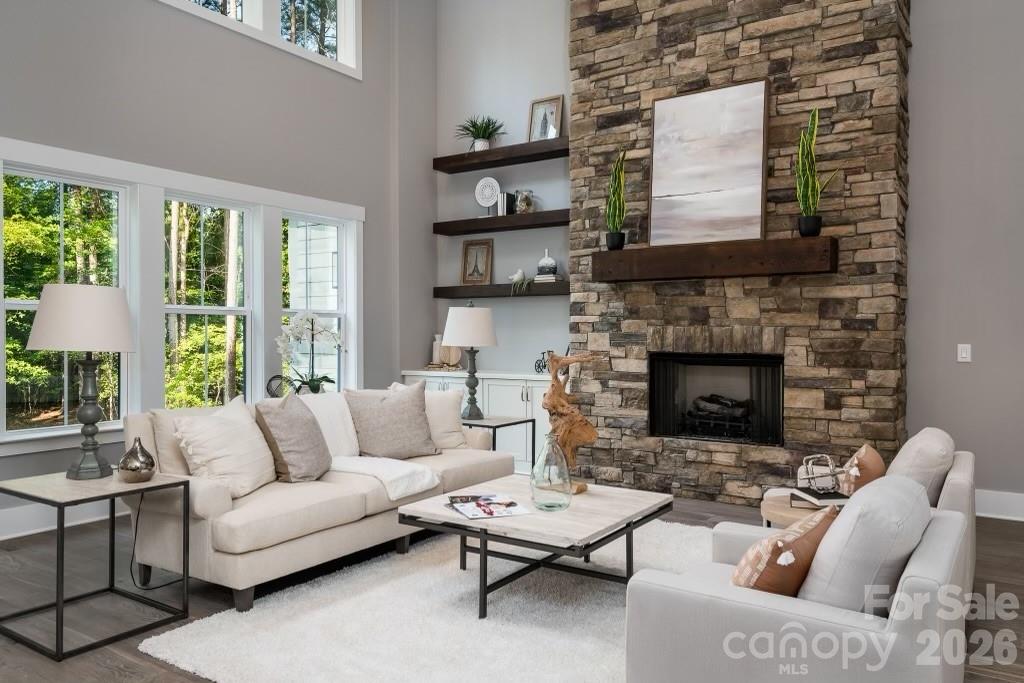 116 Silver Falls Road Troutman, NC 28166 - Photo 13 of 46 a living room with furniture and a fireplace