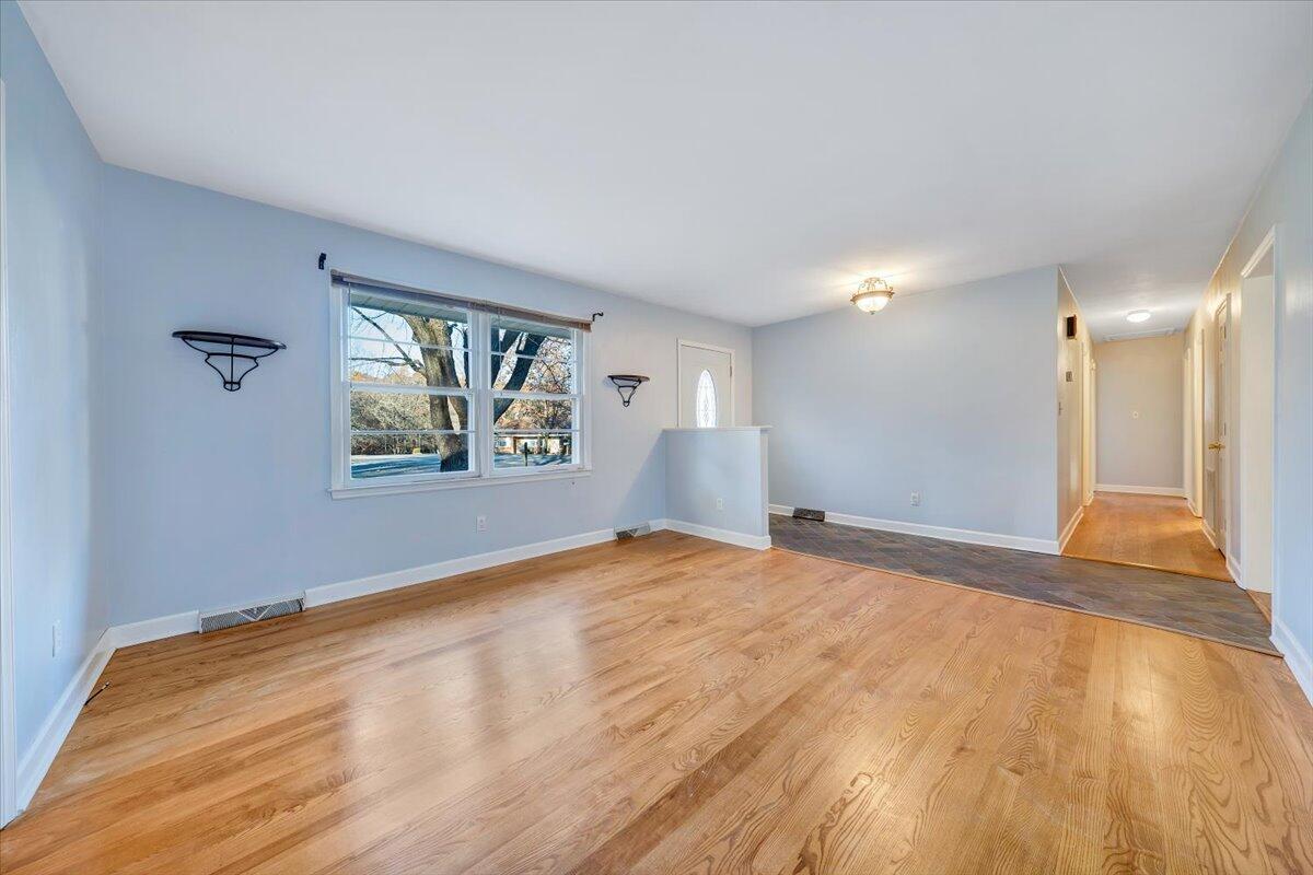 88 Persimmon Court Blue Ridge, VA 24064 - Photo 3 of 37 a view of an empty room with wooden floor and a window