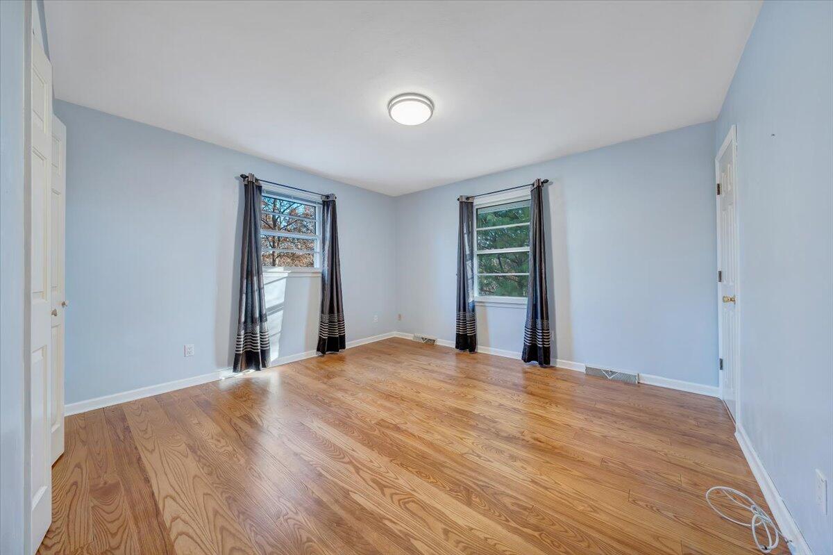 88 Persimmon Court Blue Ridge, VA 24064 - Photo 22 of 37 a view of an empty room with window and hardwood floor
